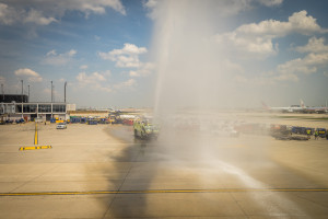 a fire truck spraying water on a runway