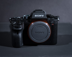 a black camera with a round lens