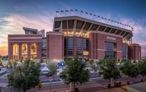 a large brick stadium with flags on top