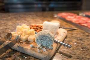 a cheese and nuts on a cutting board