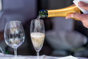 a person pouring champagne into a glass
