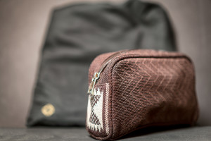 a small brown bag next to a black bag