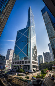 a tall building with a glass tower with Bank of China Tower in the background