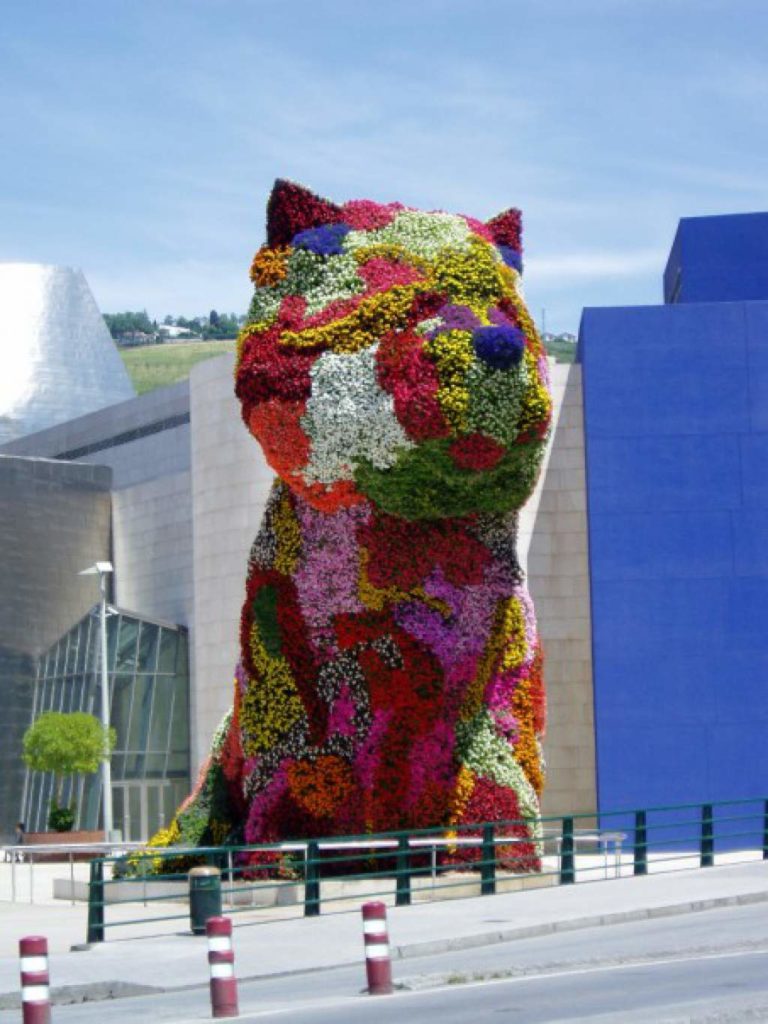 a statue of a cat made of flowers