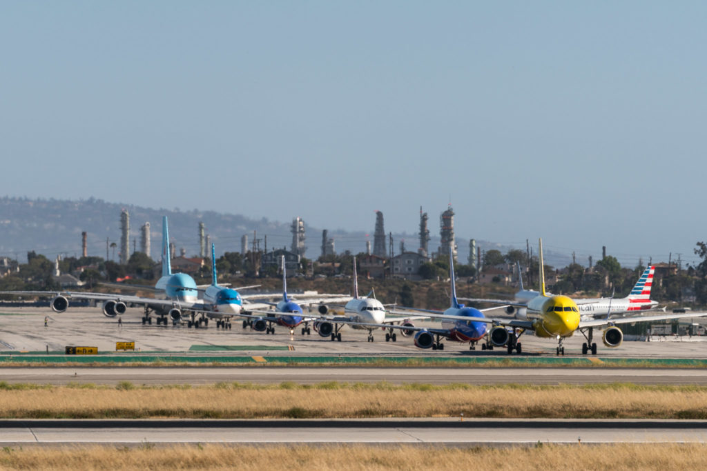 a group of airplanes on a runway