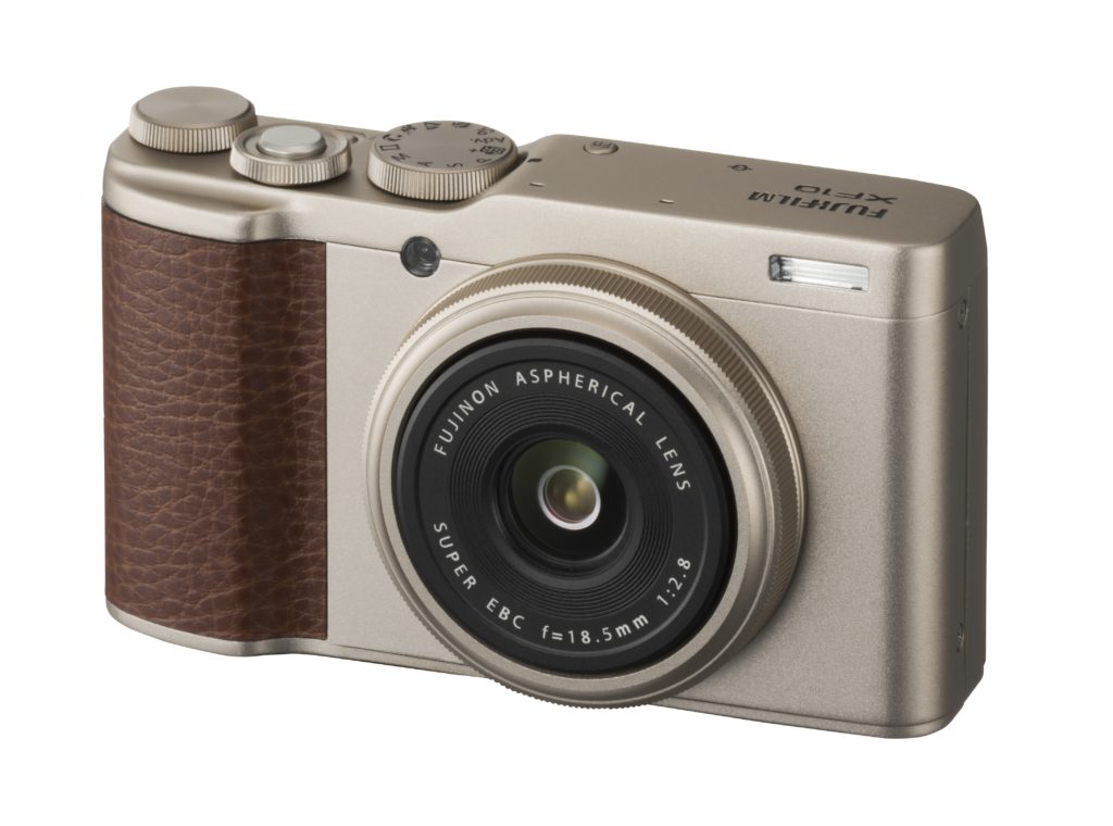 a silver camera with a brown leather cover
