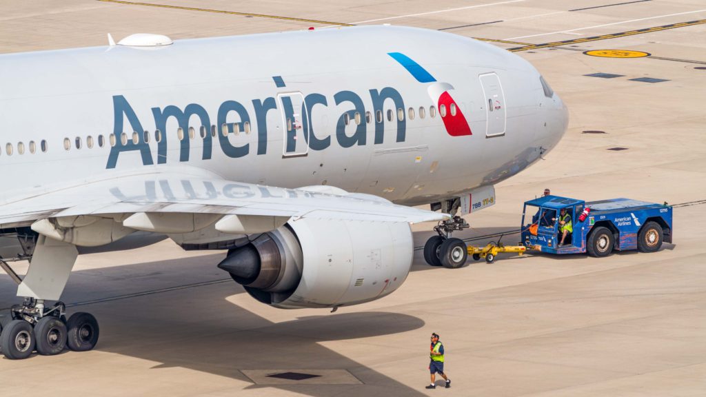 a man walking next to a large airplane
