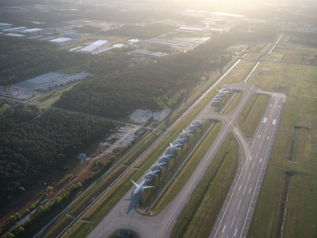 an aerial view of an airport runway with airplanes on it