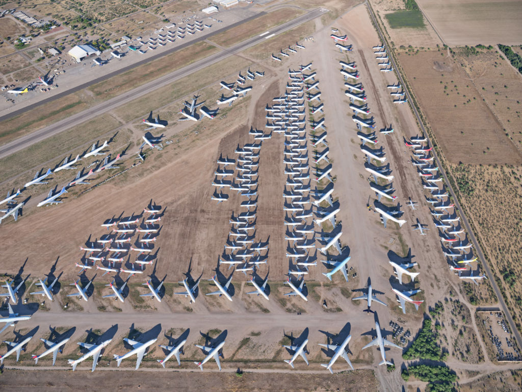 an aerial view of airplanes parked in a field