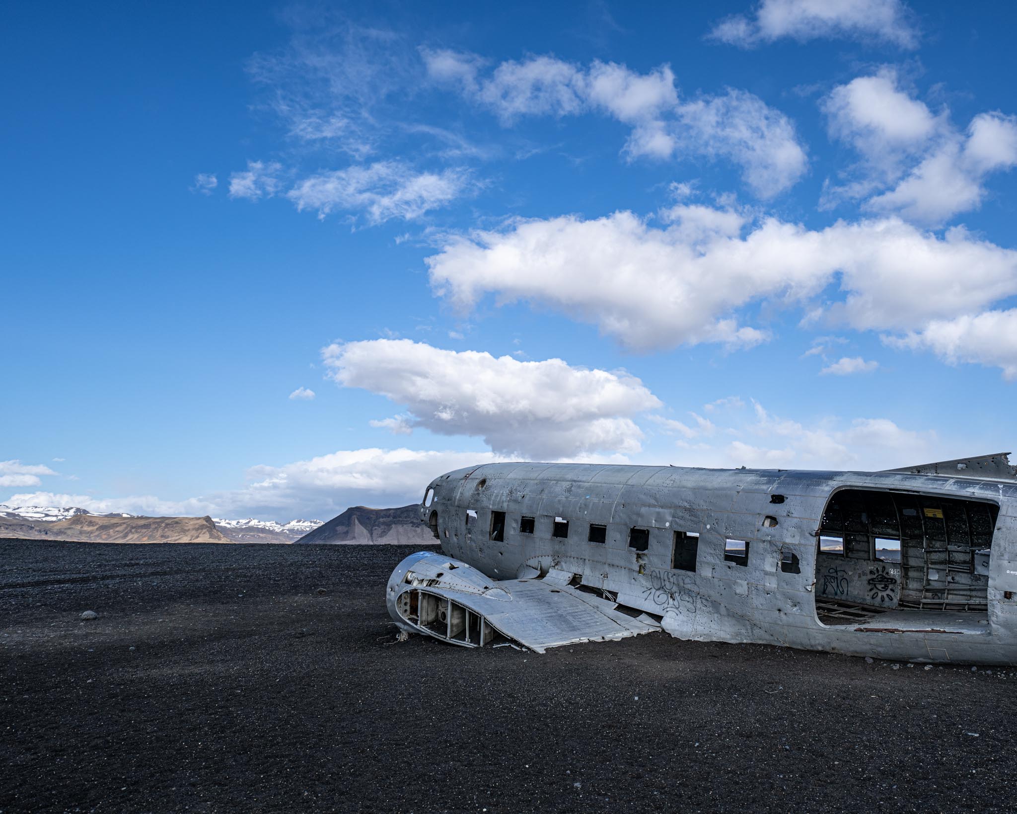 an old airplane in a black desert