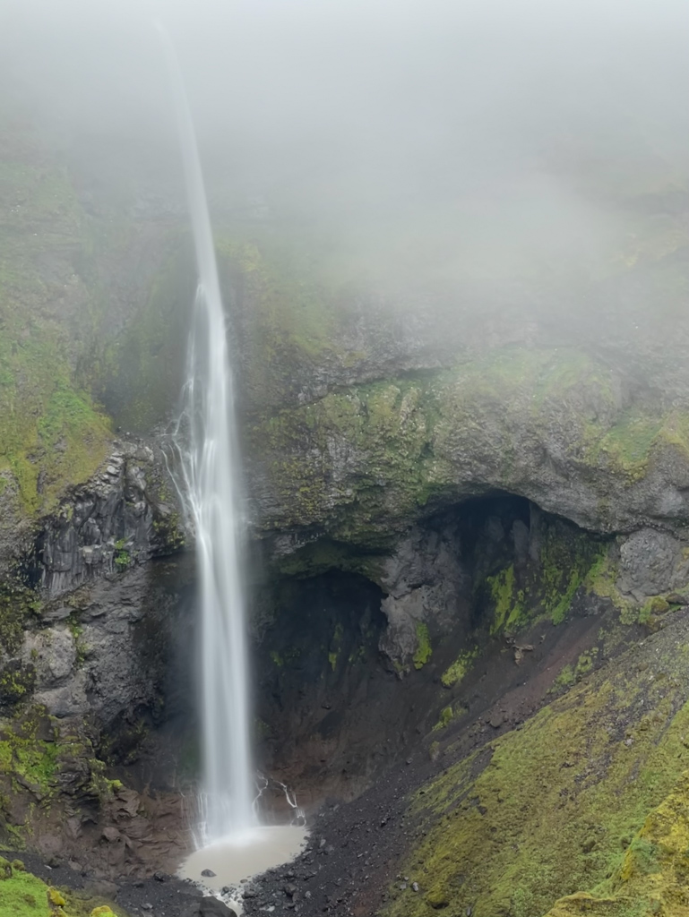 a waterfall in the fog