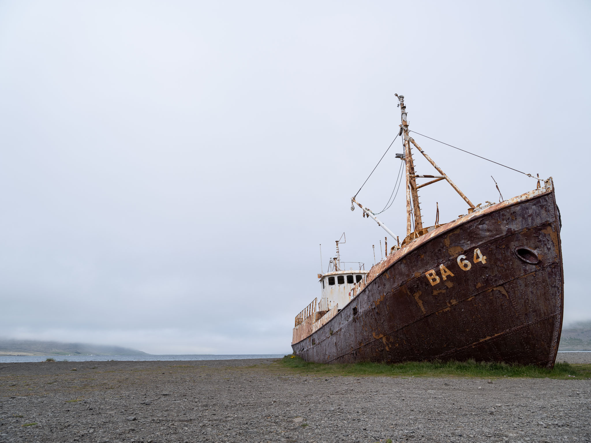 a rusty boat on a beach
