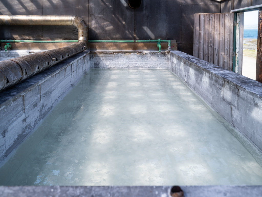 a concrete pool with water and pipes