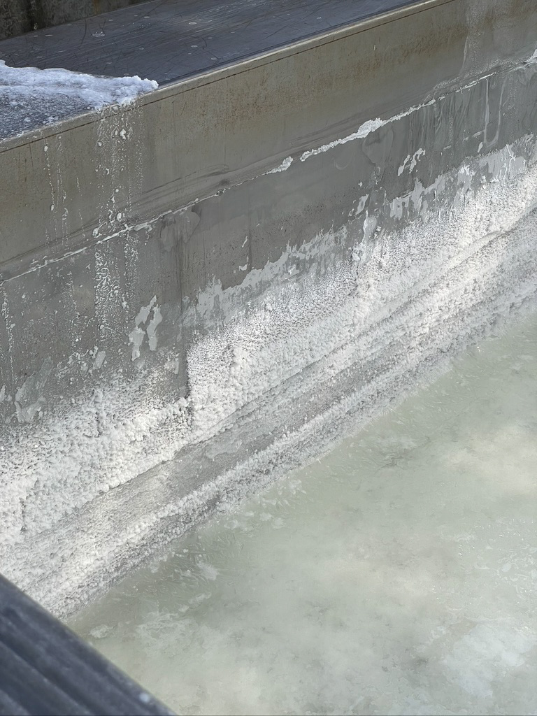 a concrete wall with white foam
