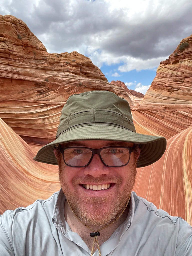 a man taking a selfie in a canyon