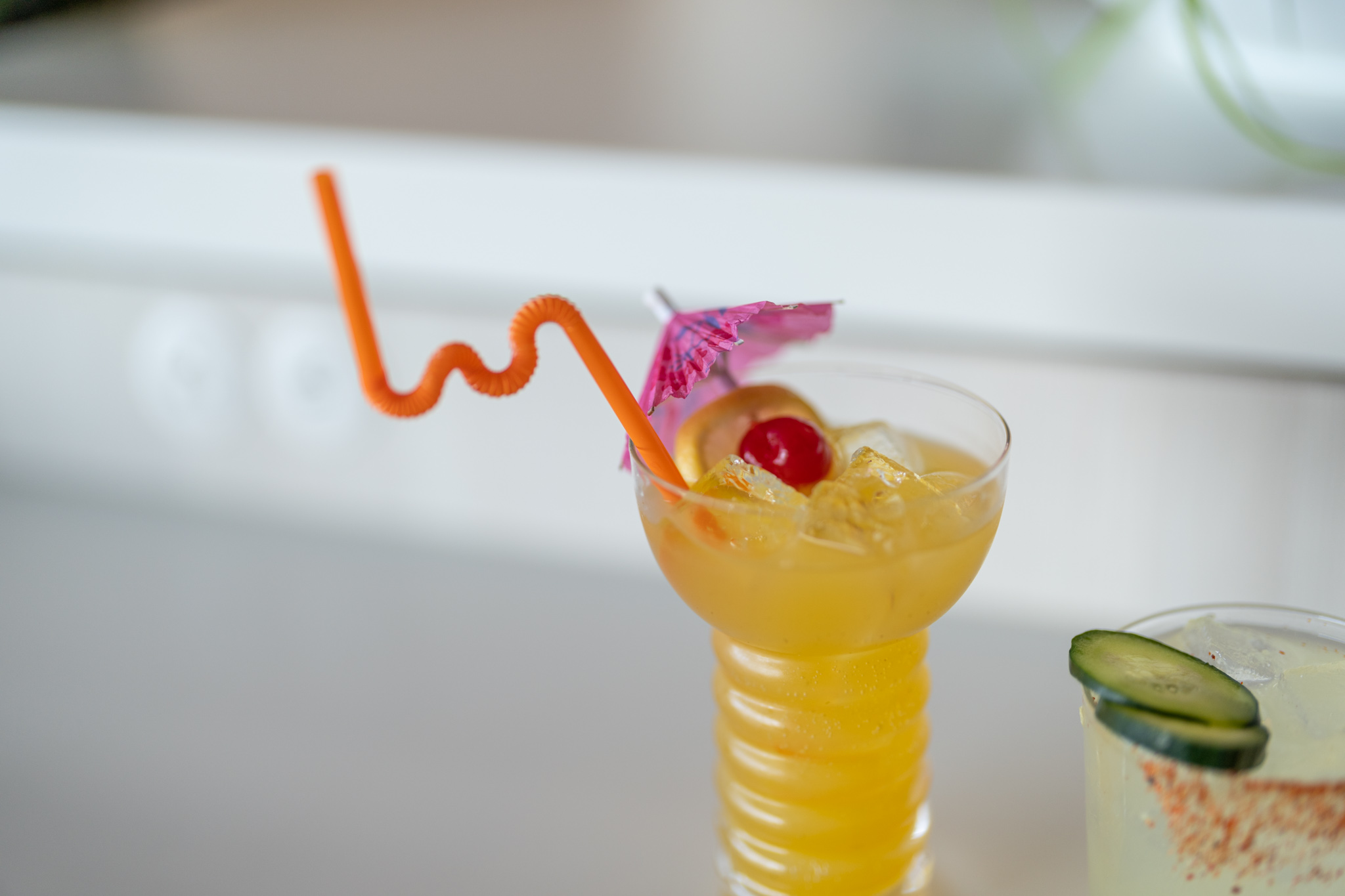a glass with a straw and a yellow drink