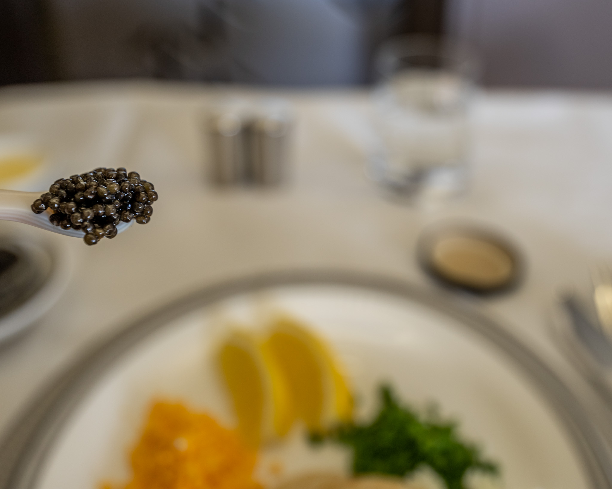 a spoon with black caviar on it