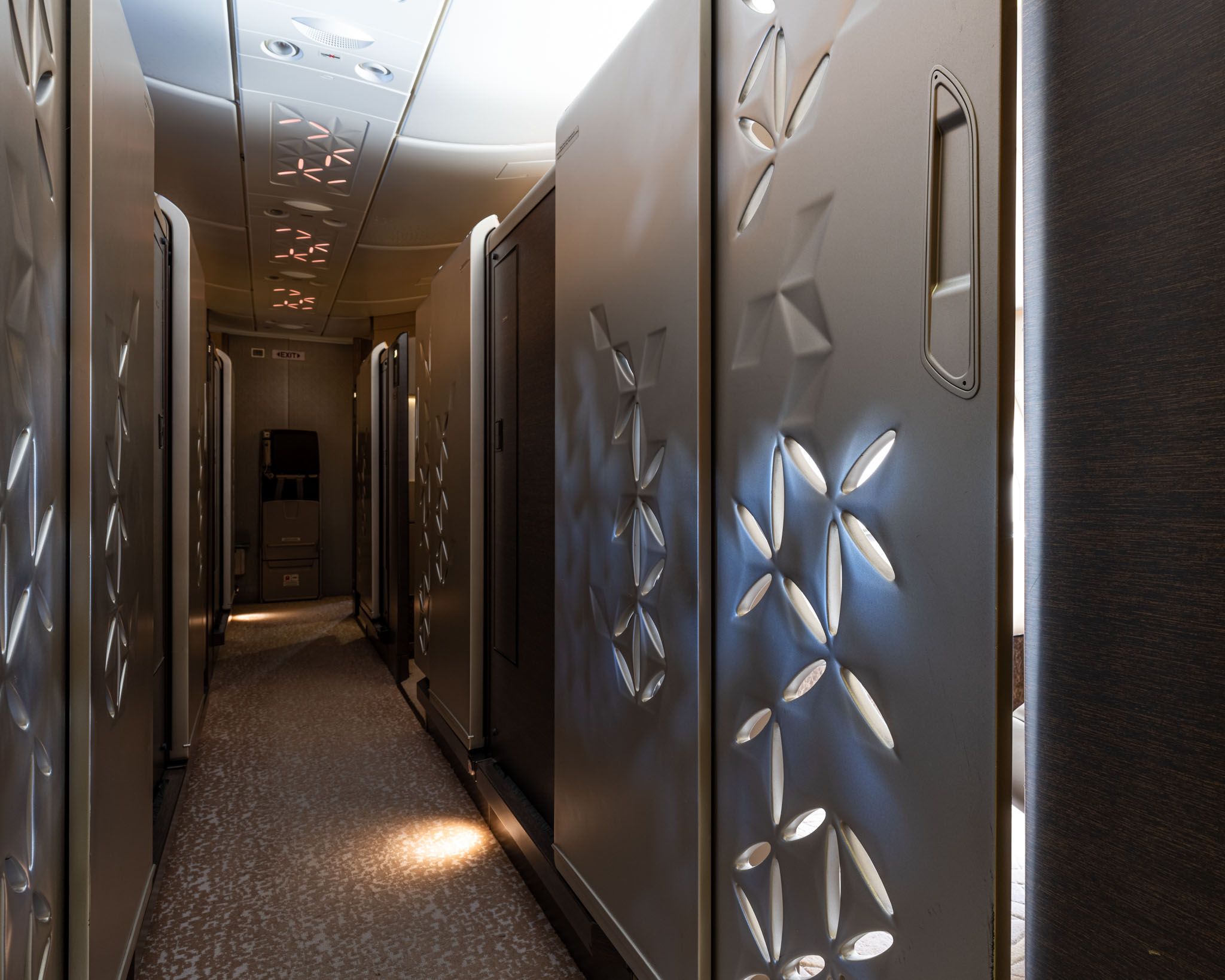 a hallway with metal doors and lights
