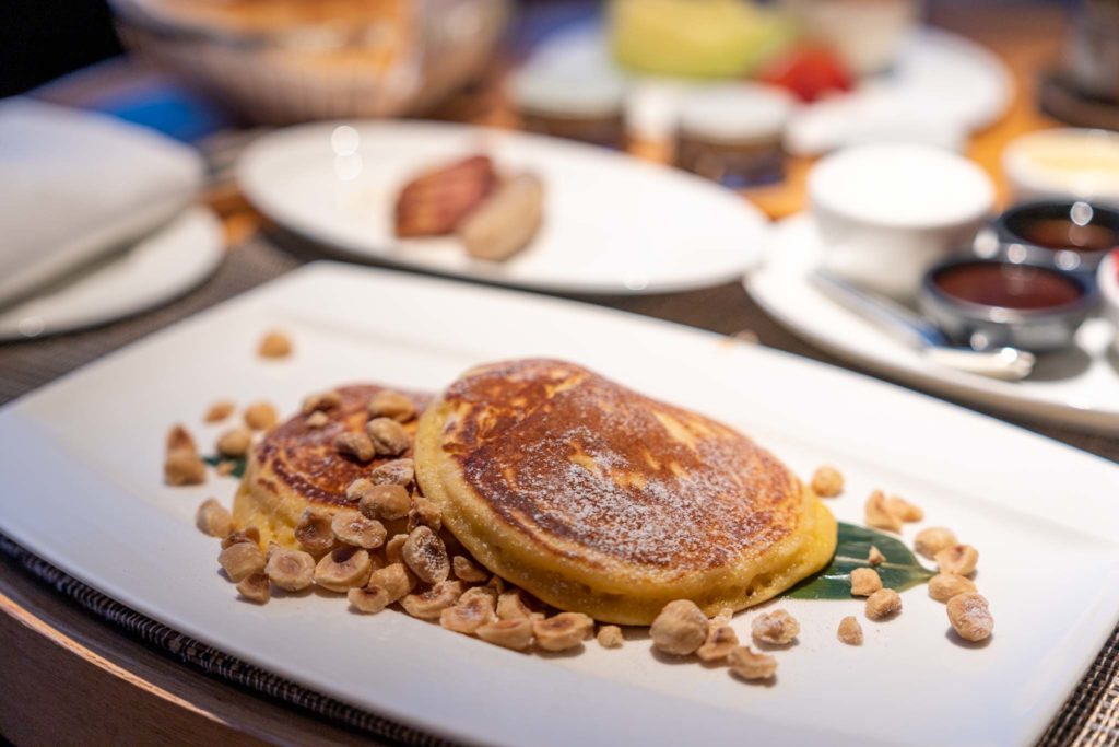 a plate of pancakes with nuts on it