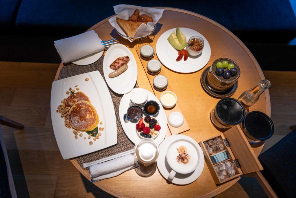 a table with plates of food and drinks