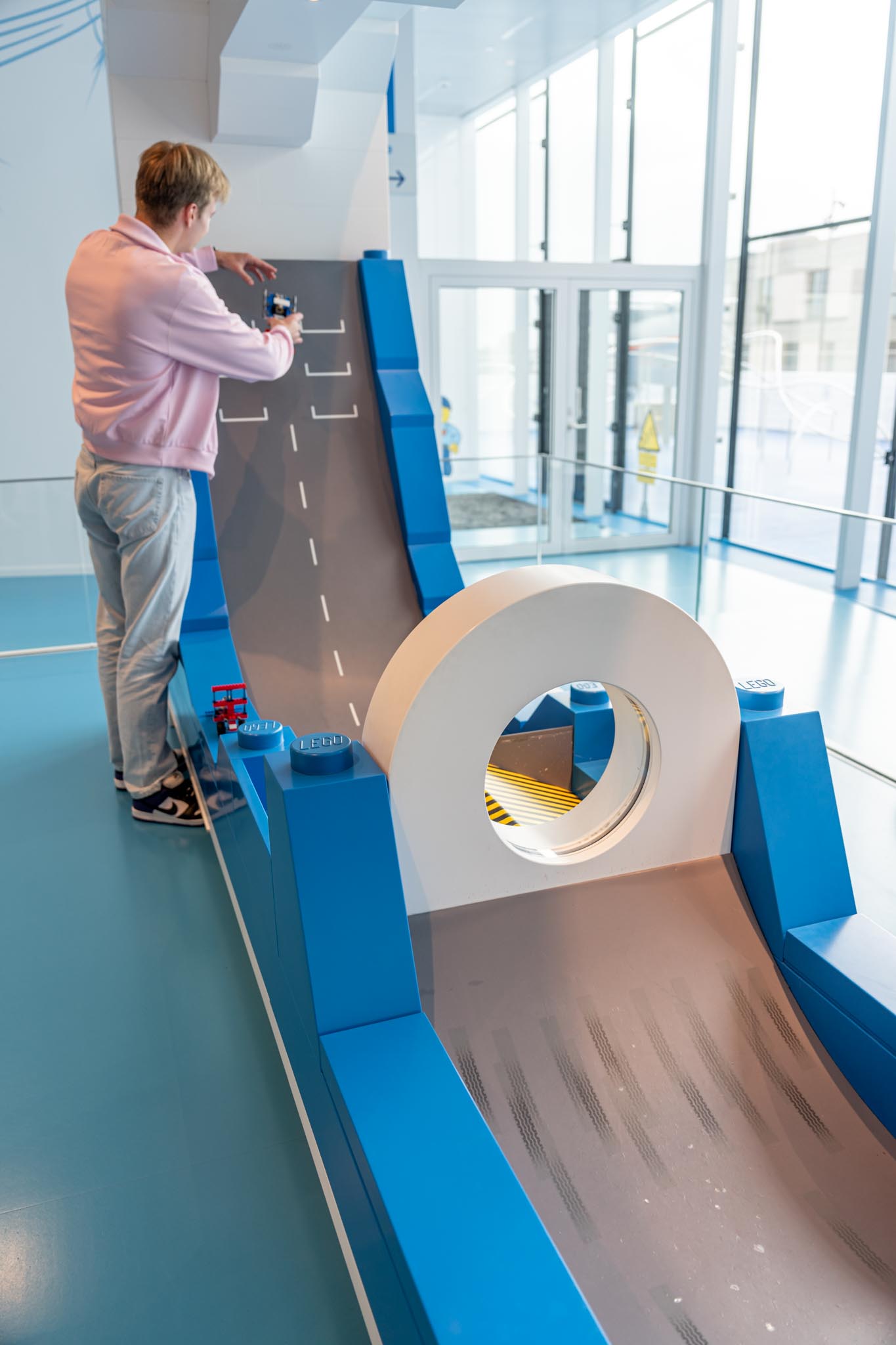 a man standing in front of a toy slide