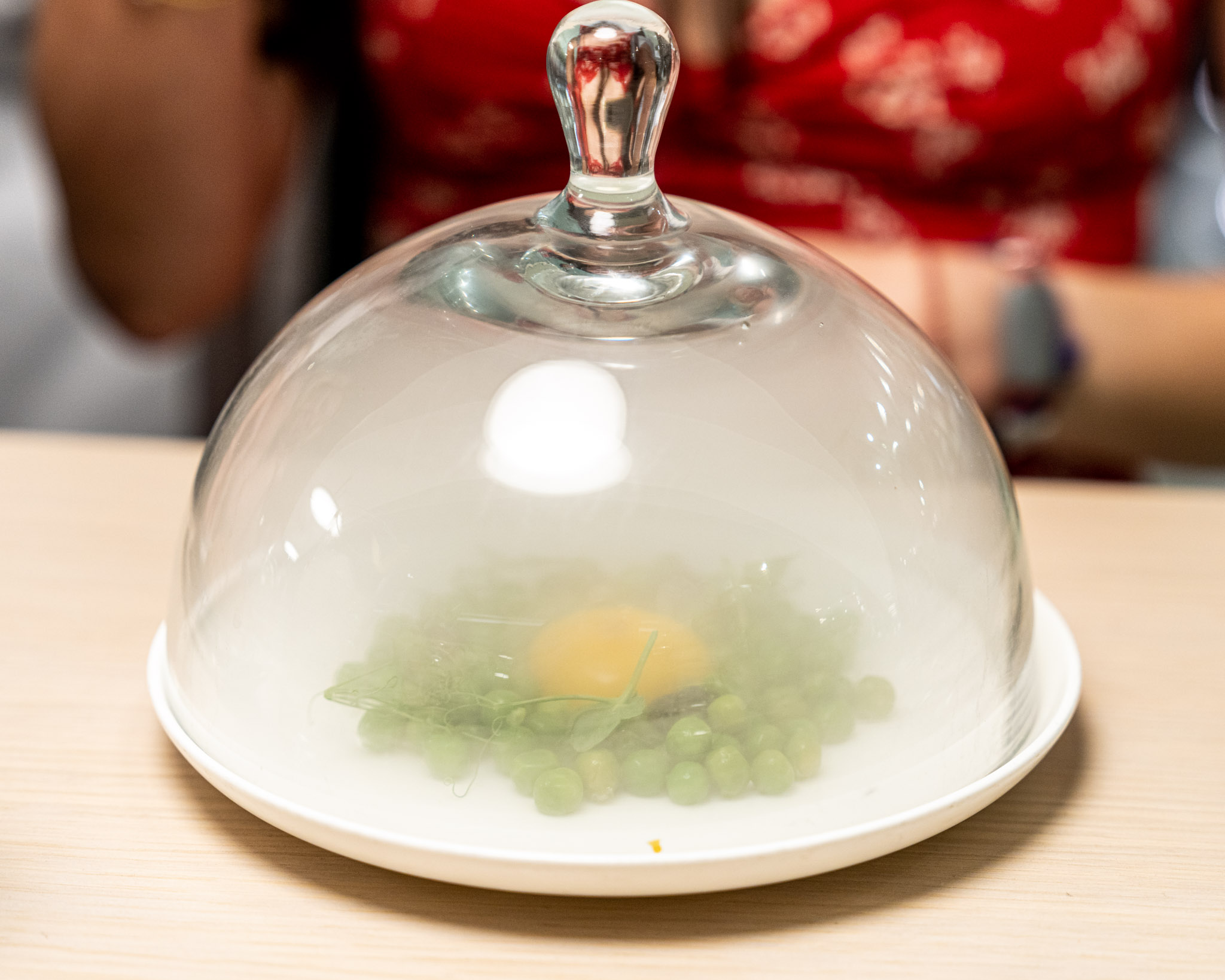 a plate with a glass cover and a egg in it