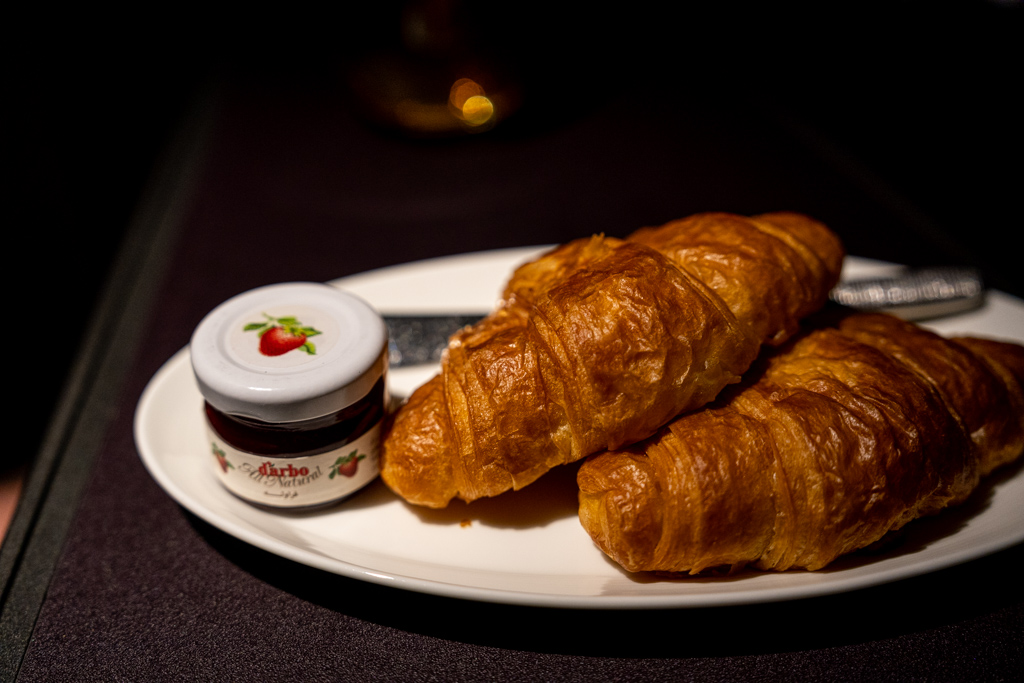 a plate of croissants and jam