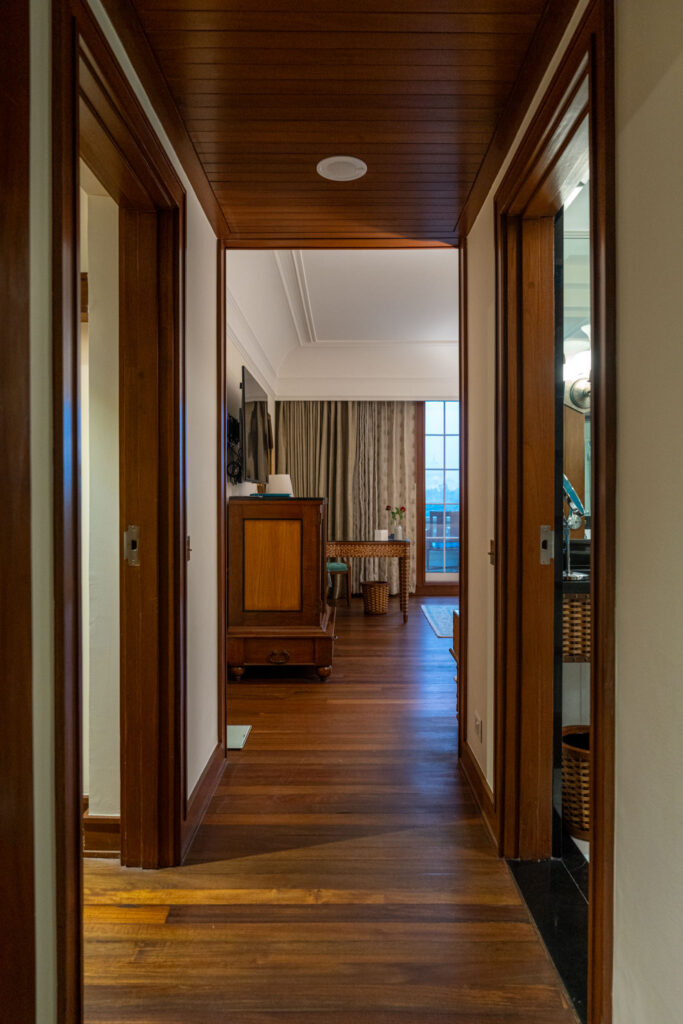 a hallway with a wood floor and a wood floor