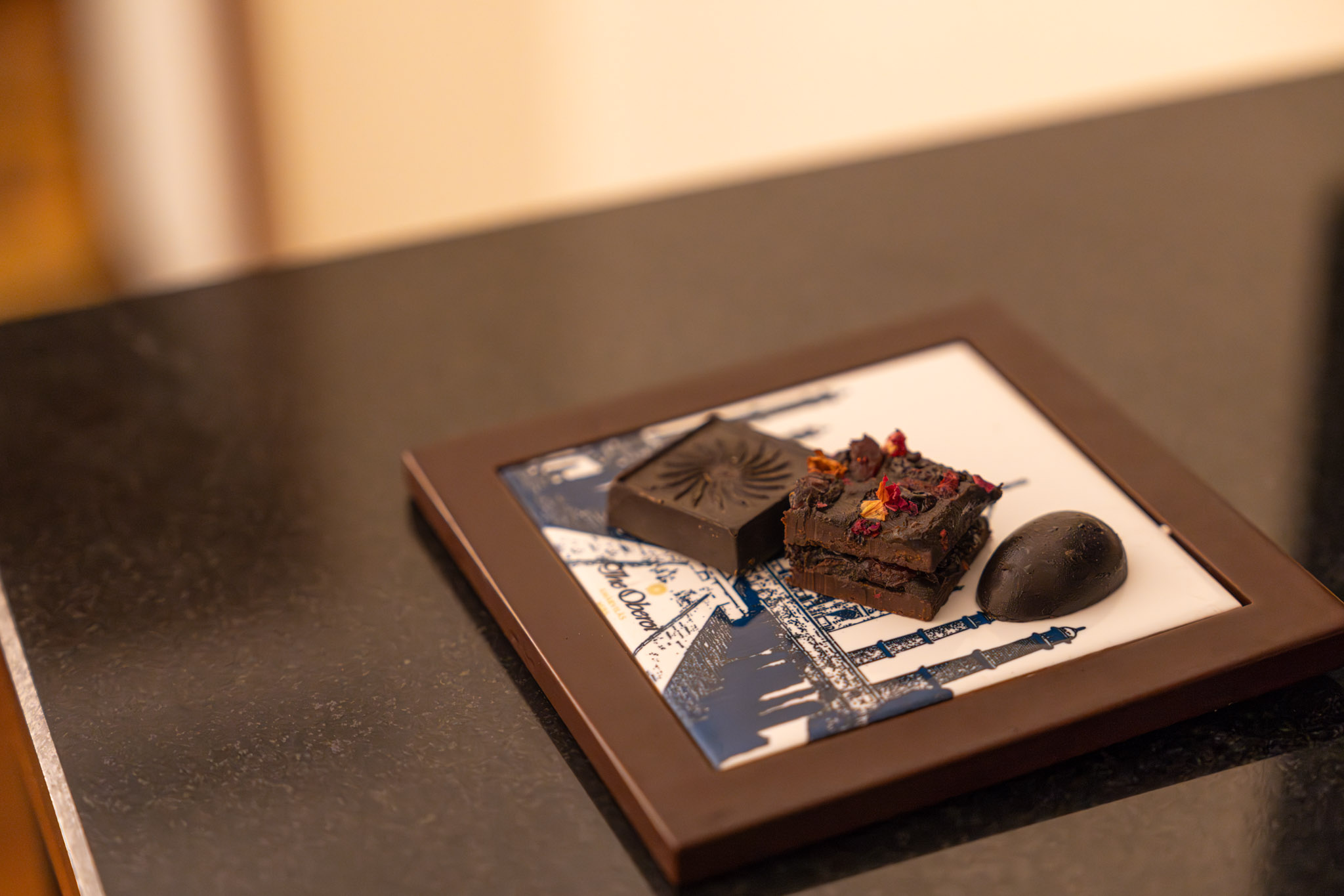 a square plate with a piece of chocolate on it