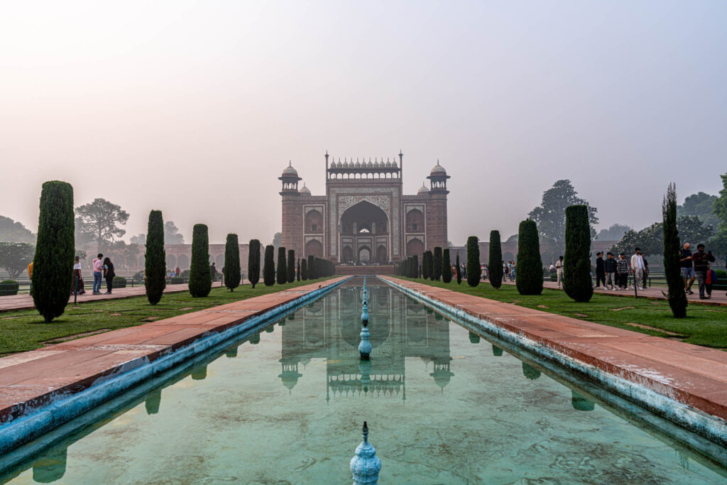 a pool of water in front of Taj Mahal