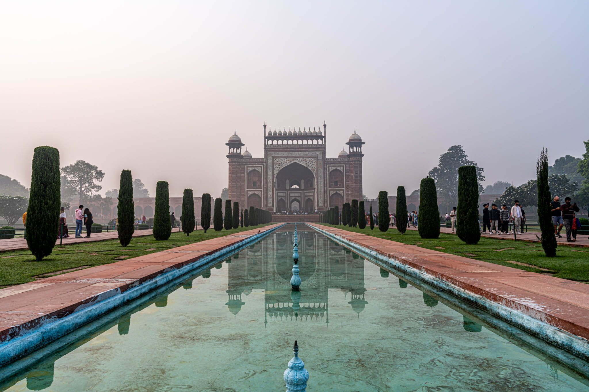 a pool of water in front of Taj Mahal