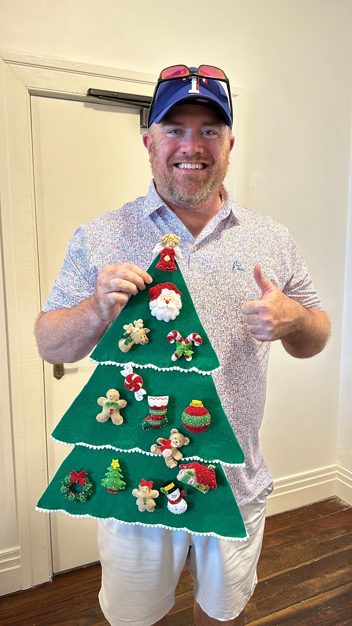 a man holding a christmas tree