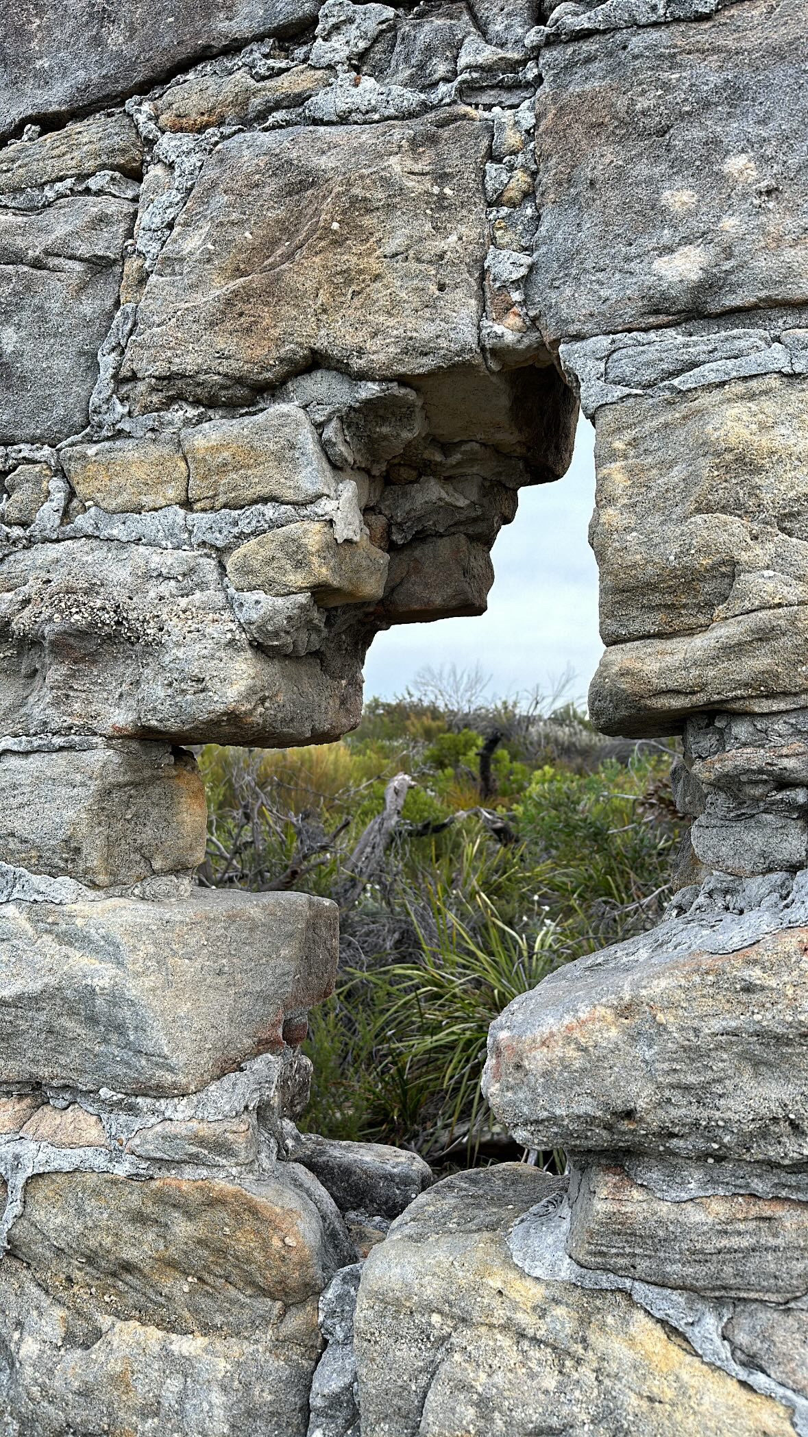 a stone wall with a hole in it