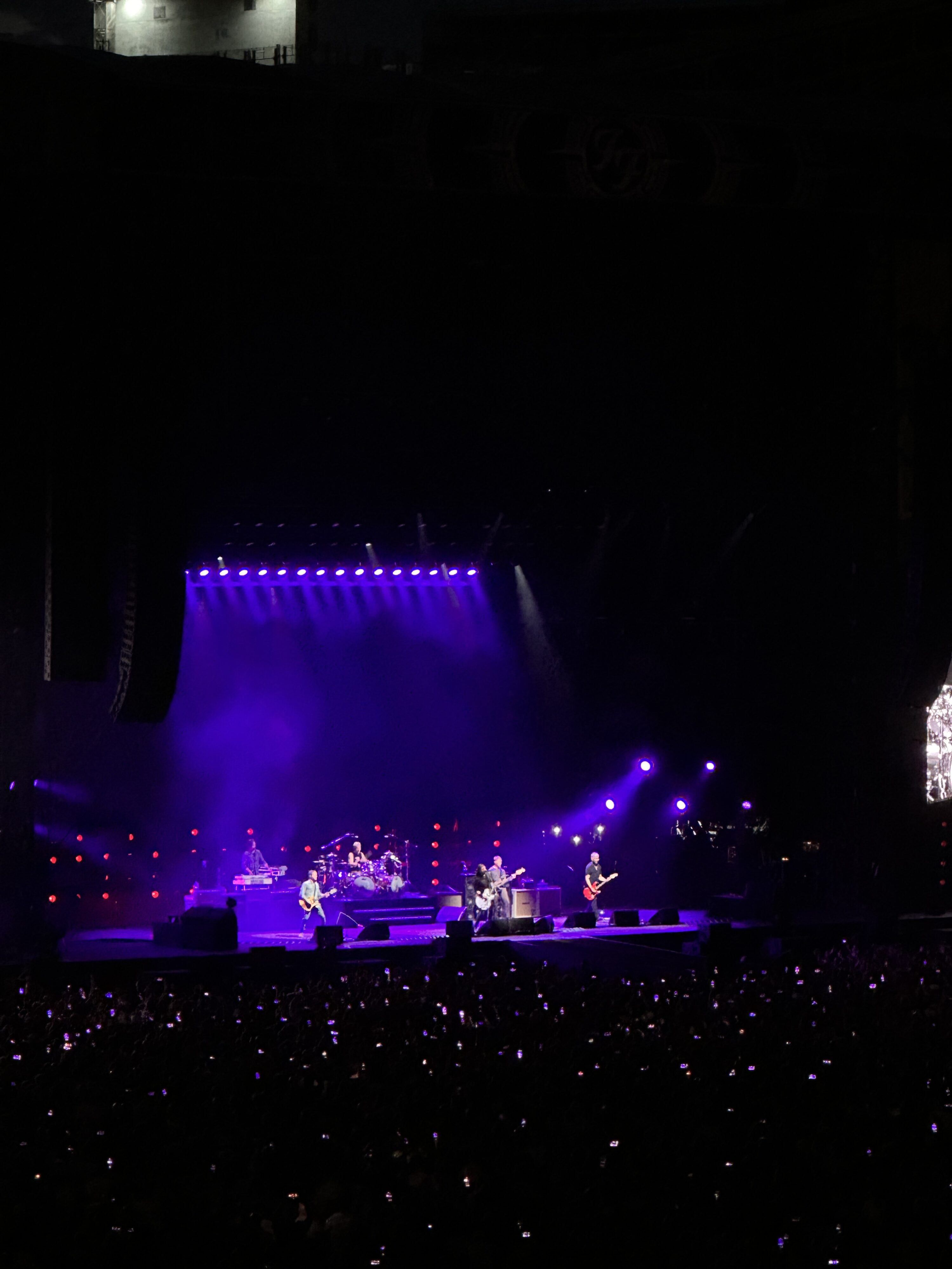 a band on stage with purple lights