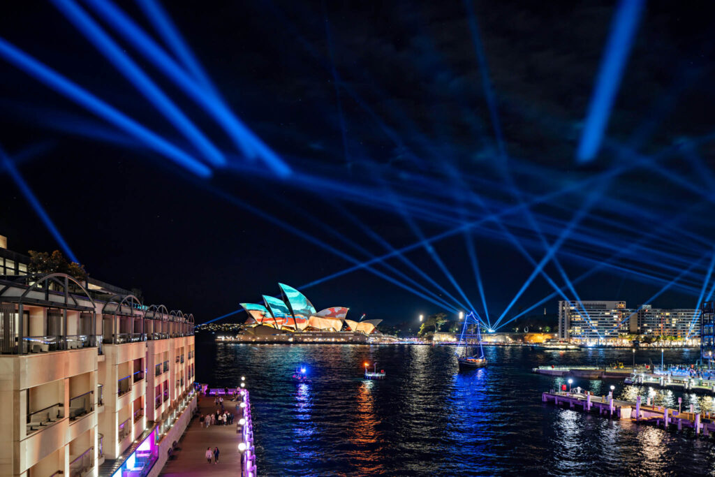 a large building with blue lights coming out of it