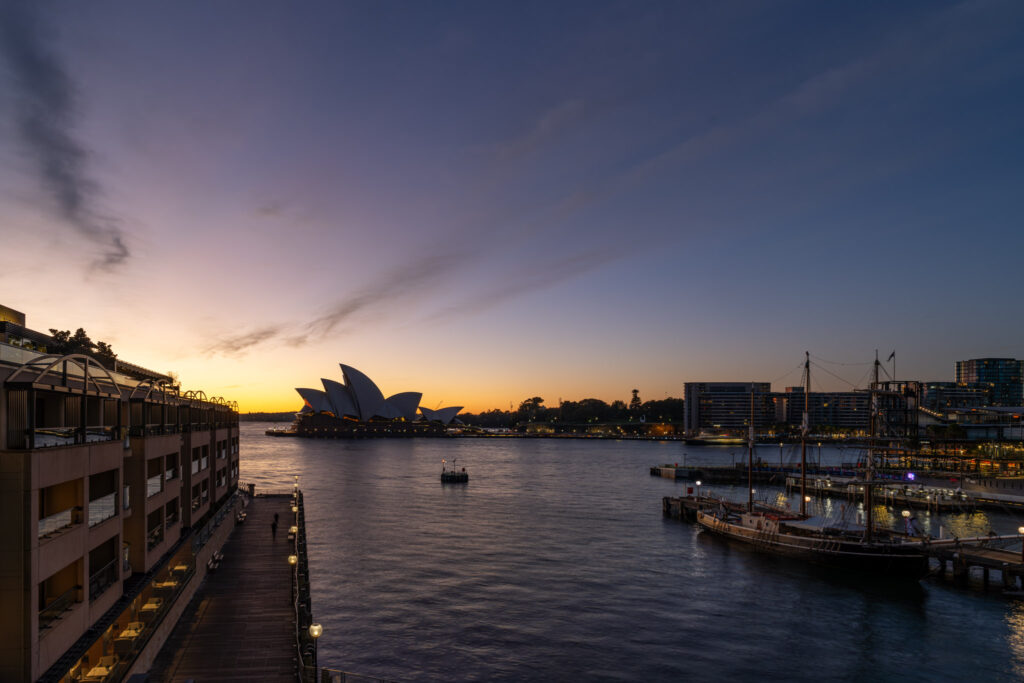 a body of water with boats and buildings in the background