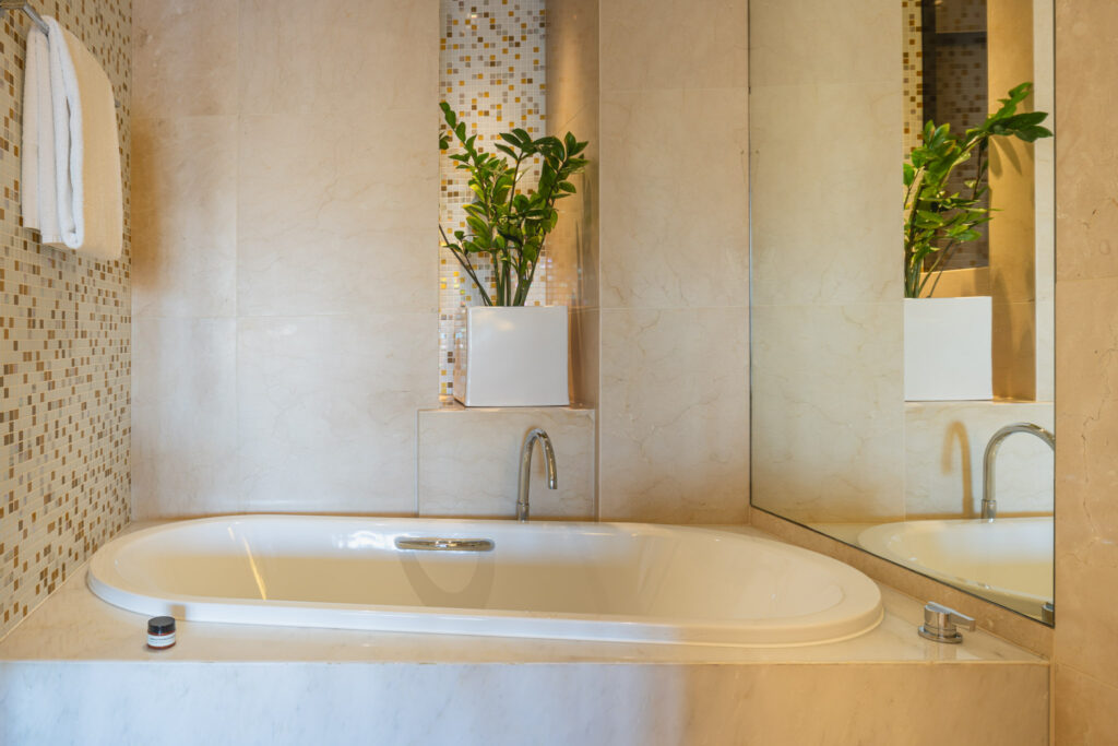 a bathtub and a mirror in a bathroom