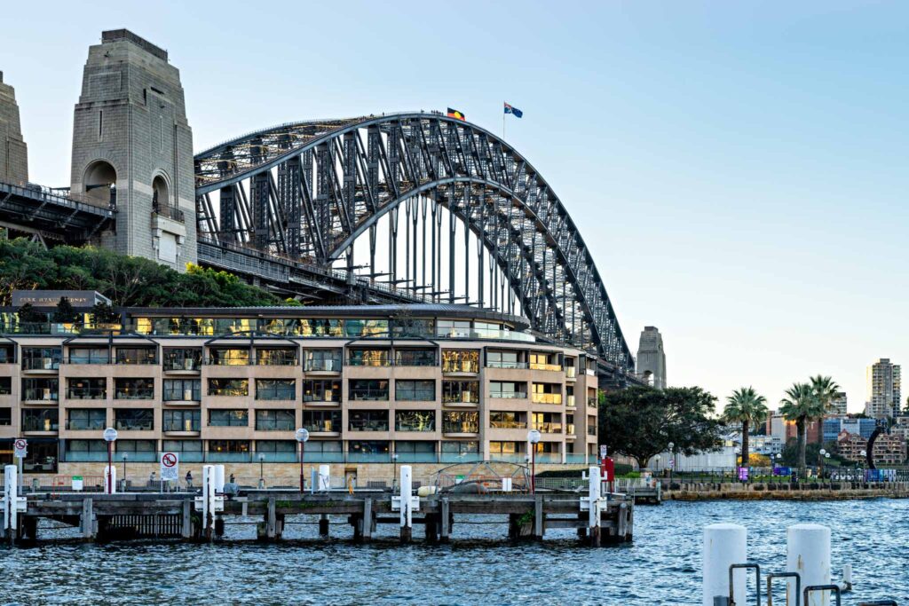 a bridge over water with buildings and trees