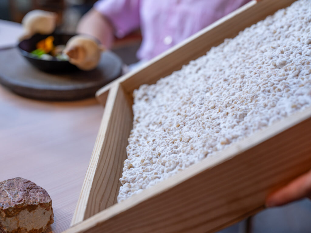 a wooden box with white grains