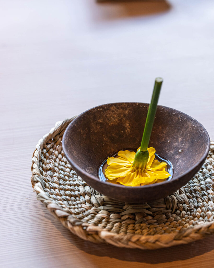 a bowl with a flower in it