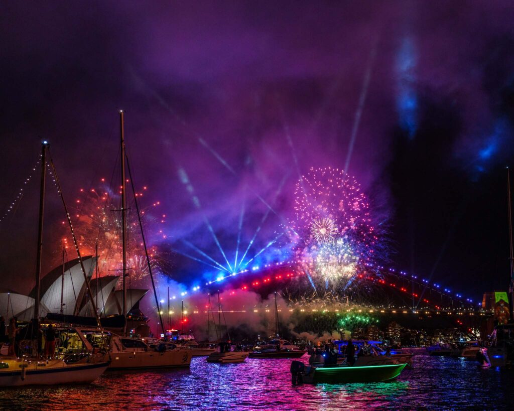 fireworks over a bridge at night