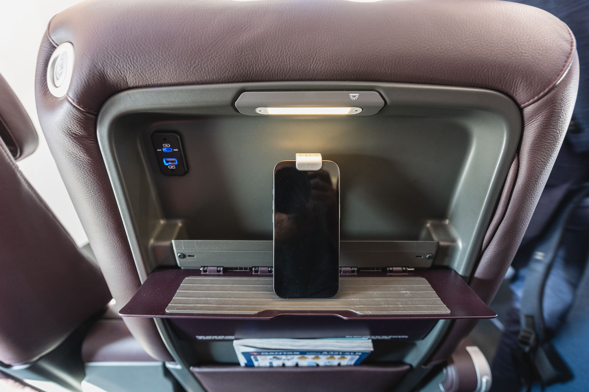 a phone on a shelf in a seat