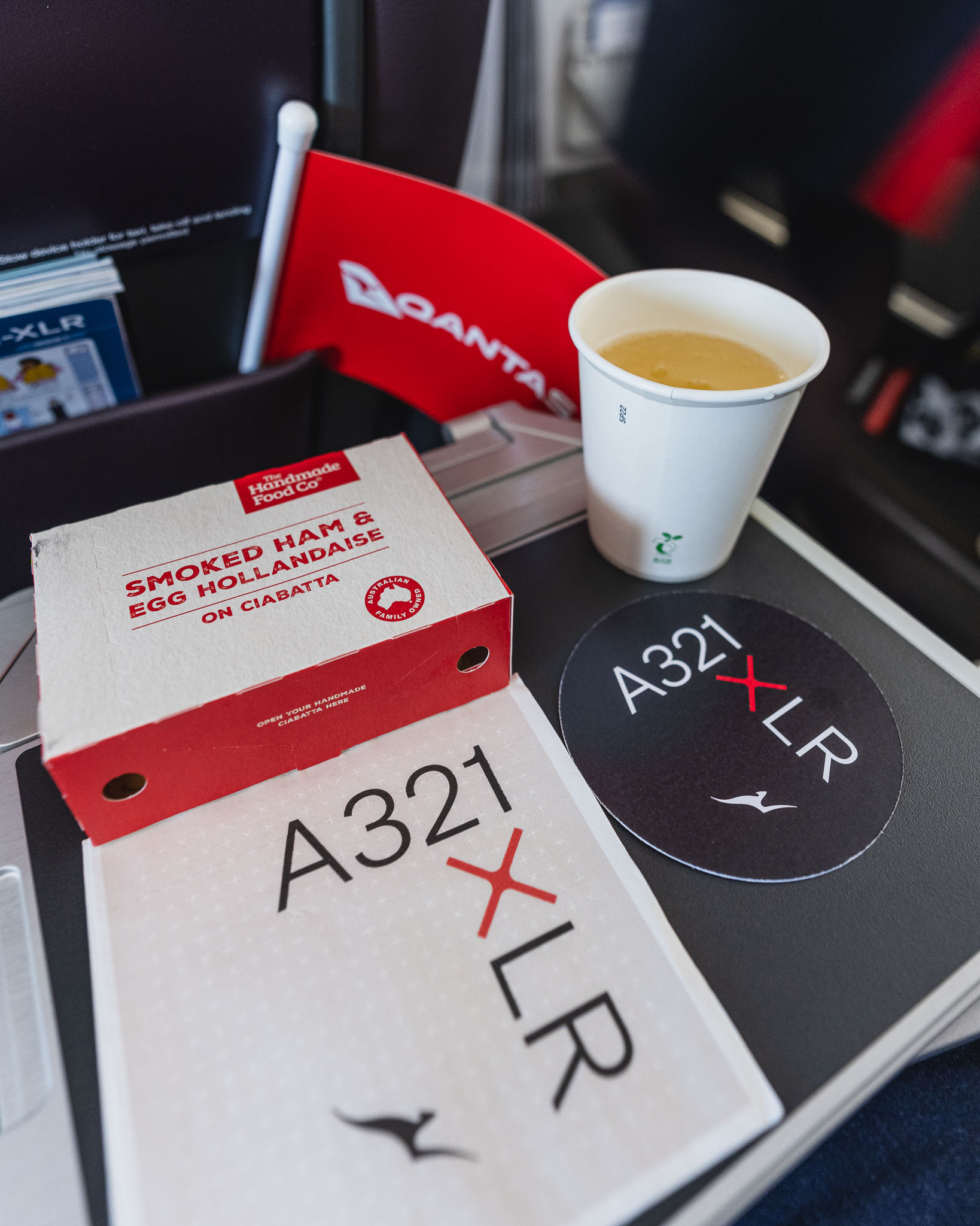 a white cup and a cardboard box on a table