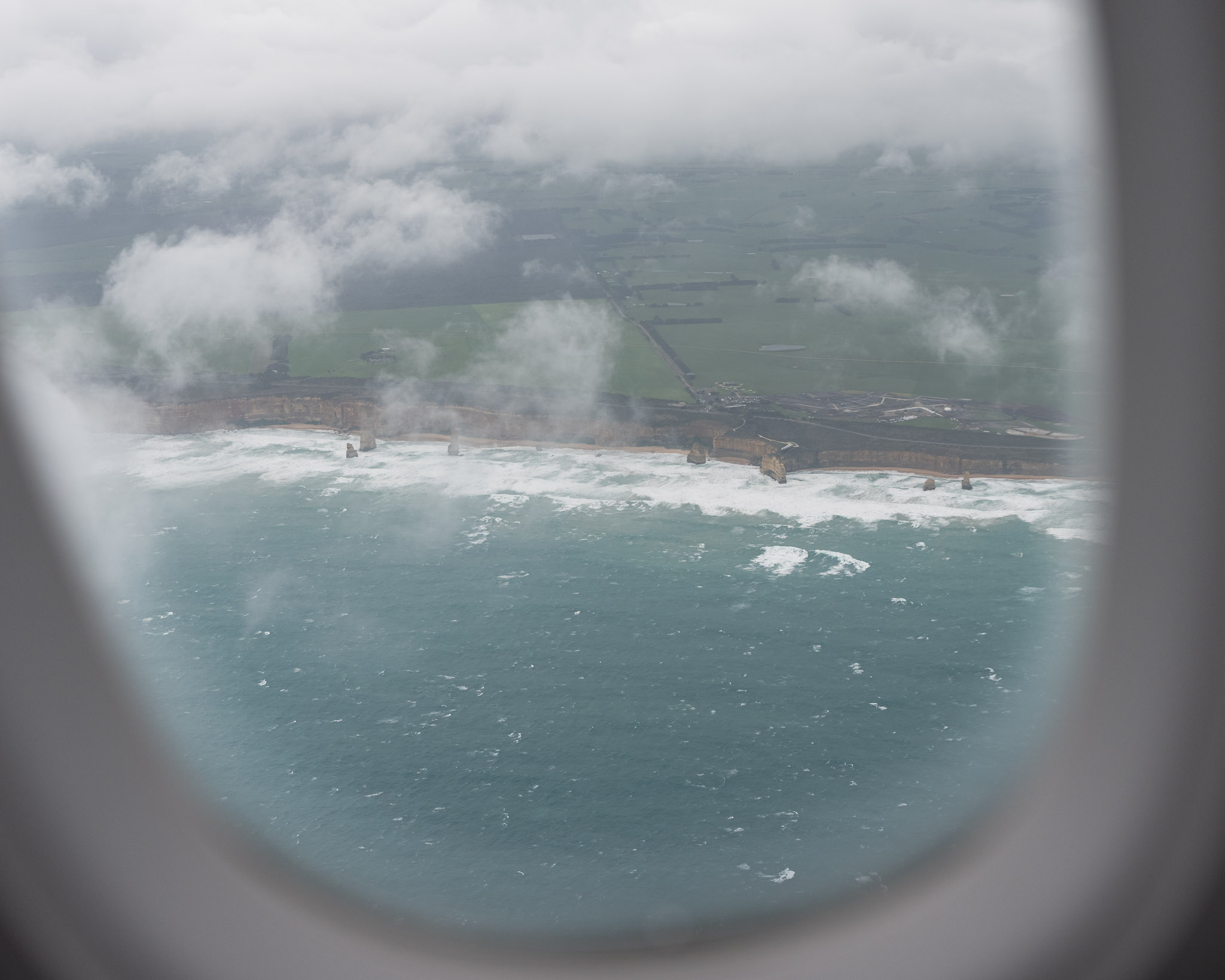 a view of the ocean from a window of an airplane