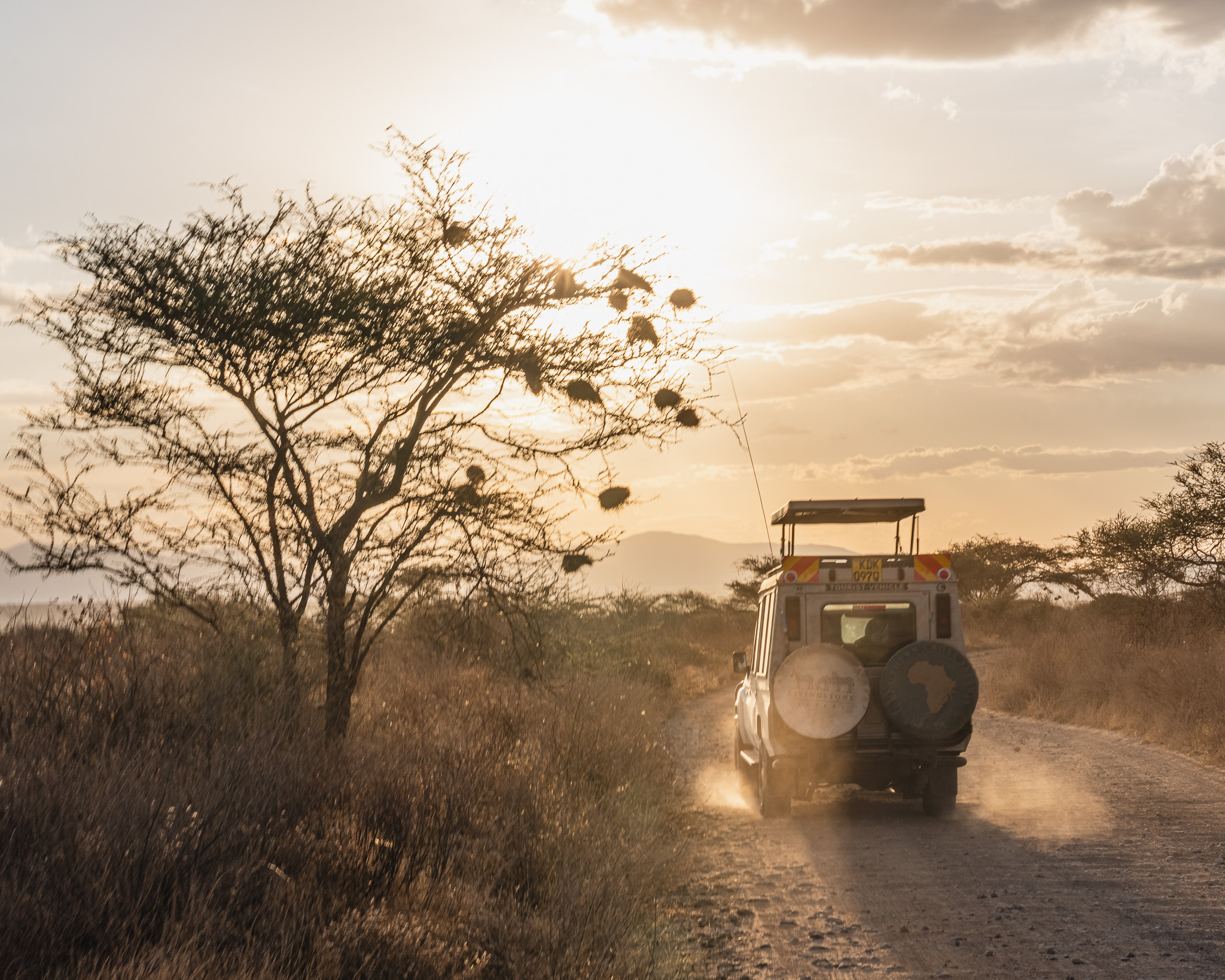 a vehicle driving on a dirt road