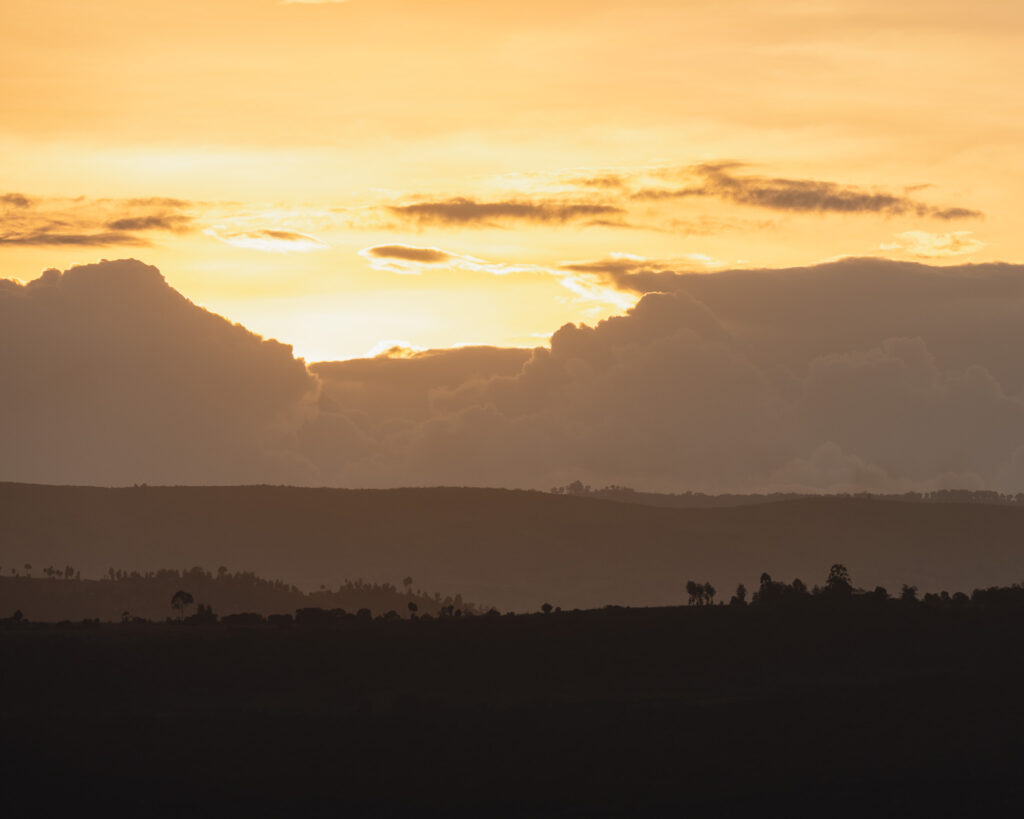 a sunset over a mountain