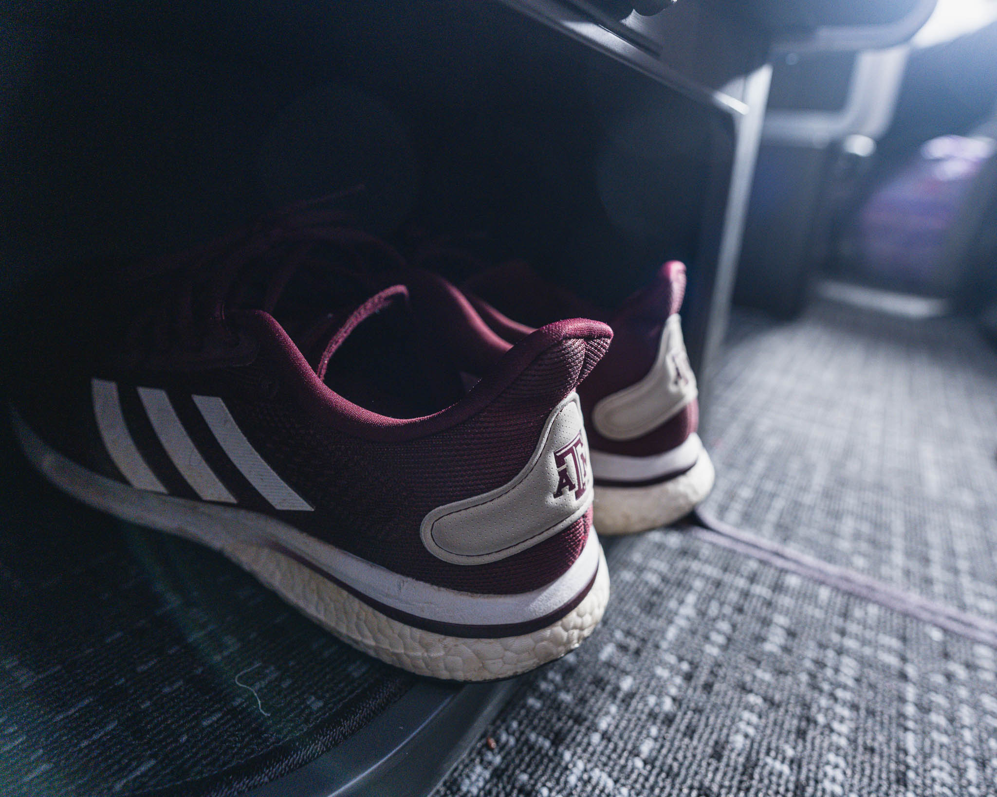 a pair of maroon and white tennis shoes