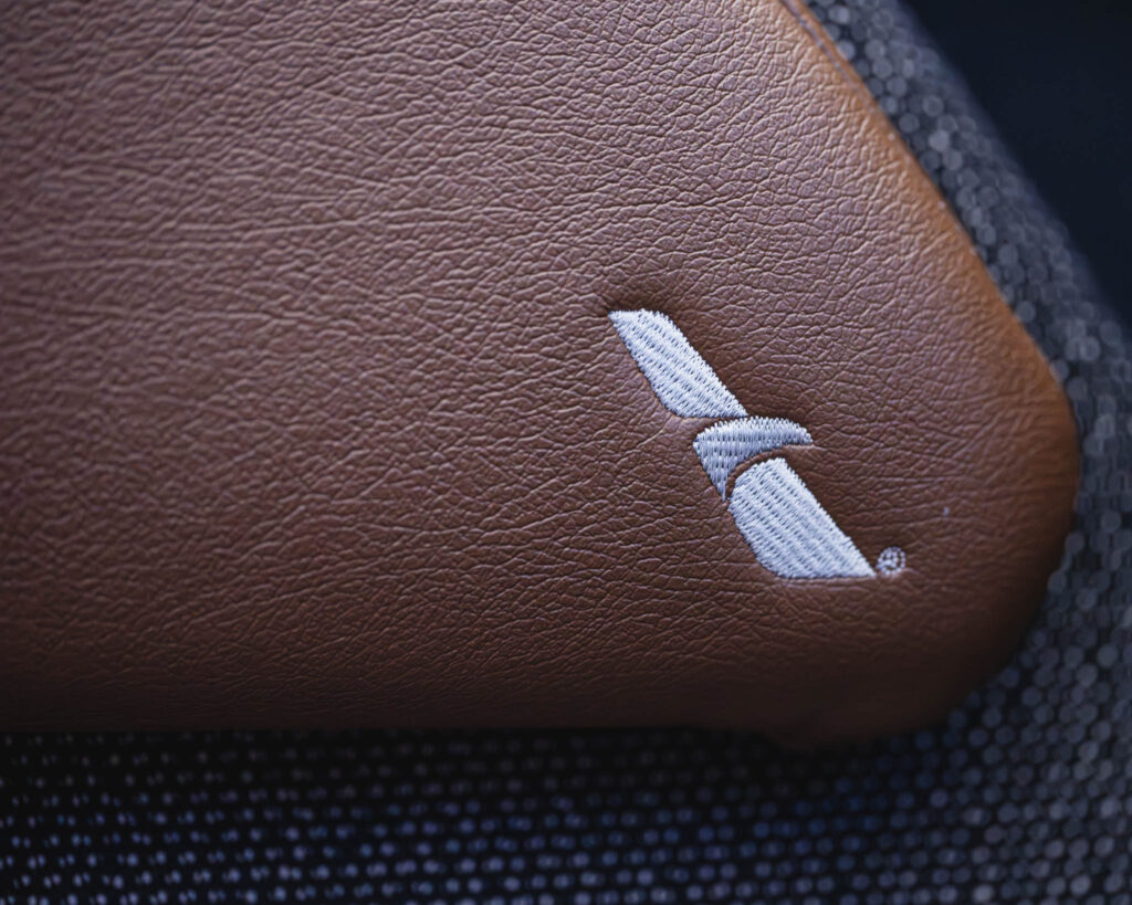 a brown leather case with a white logo on it