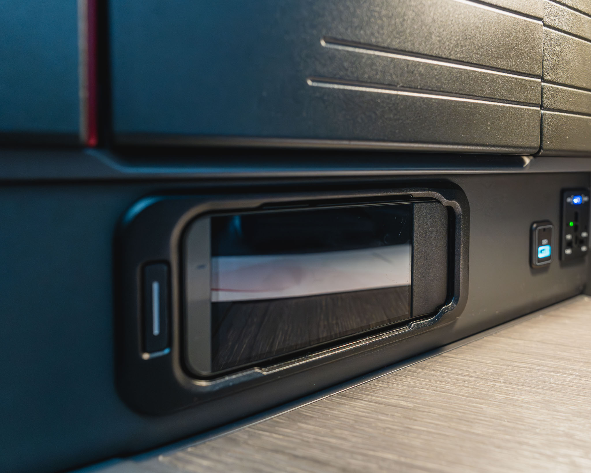 a rectangular object with a black rectangular object on a wood surface