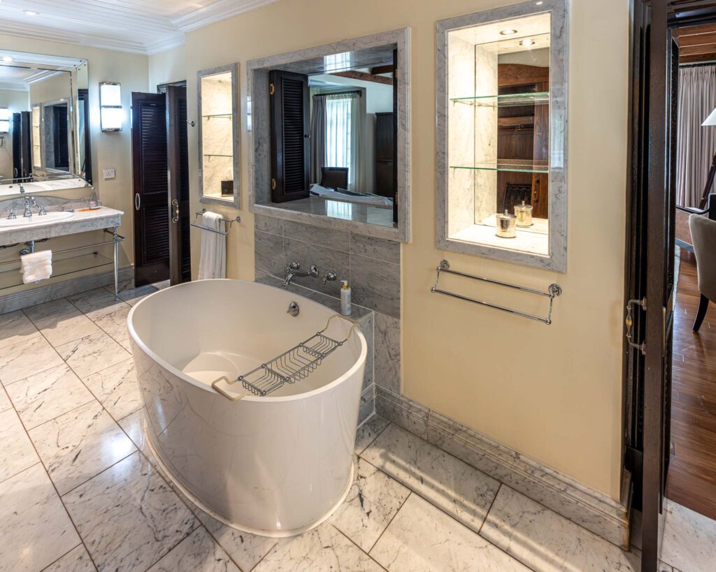 a bathroom with a tub and mirrors